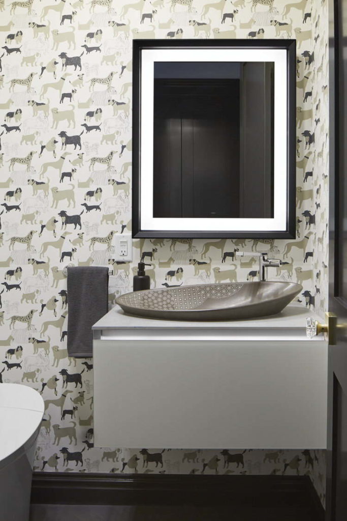 Powder room with dog wall paper and stone bowl sink. 