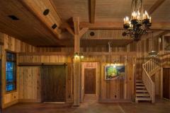 The entryway of the Party Barn has wrought-iron candlelight chandeliers and lantern-like sconces add to the rustic feel of the space.